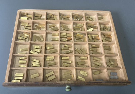 146 pieces 24pt Helvitica Medium Brass Type with Type Tray